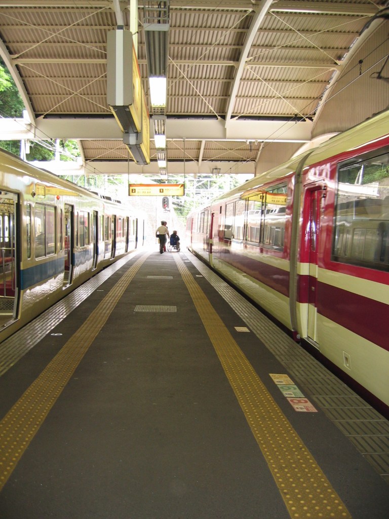 A bustling Tokyo transfer station with trains constantly moving