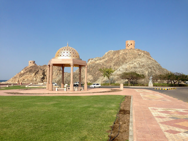 A shimmering sunset reflecting off the waters of the Muttrah Corniche.