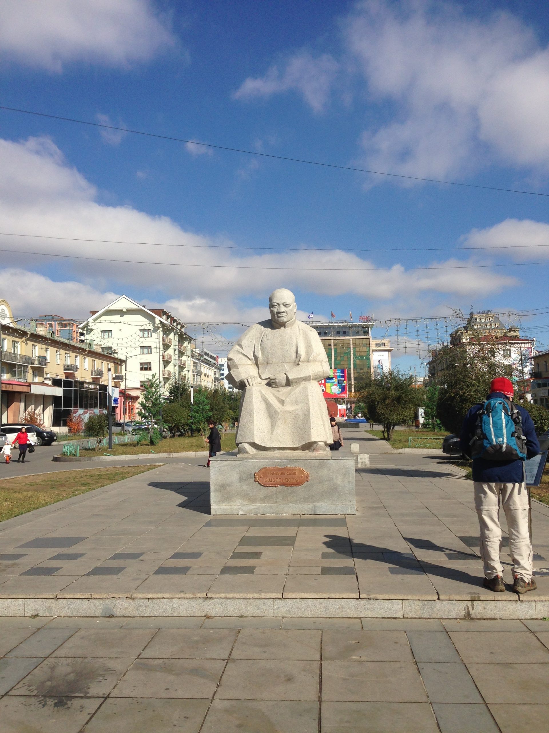 A bronze statue sitting peacefully in the middle of a public square on Seoul Street in Ulaanbaatar.
