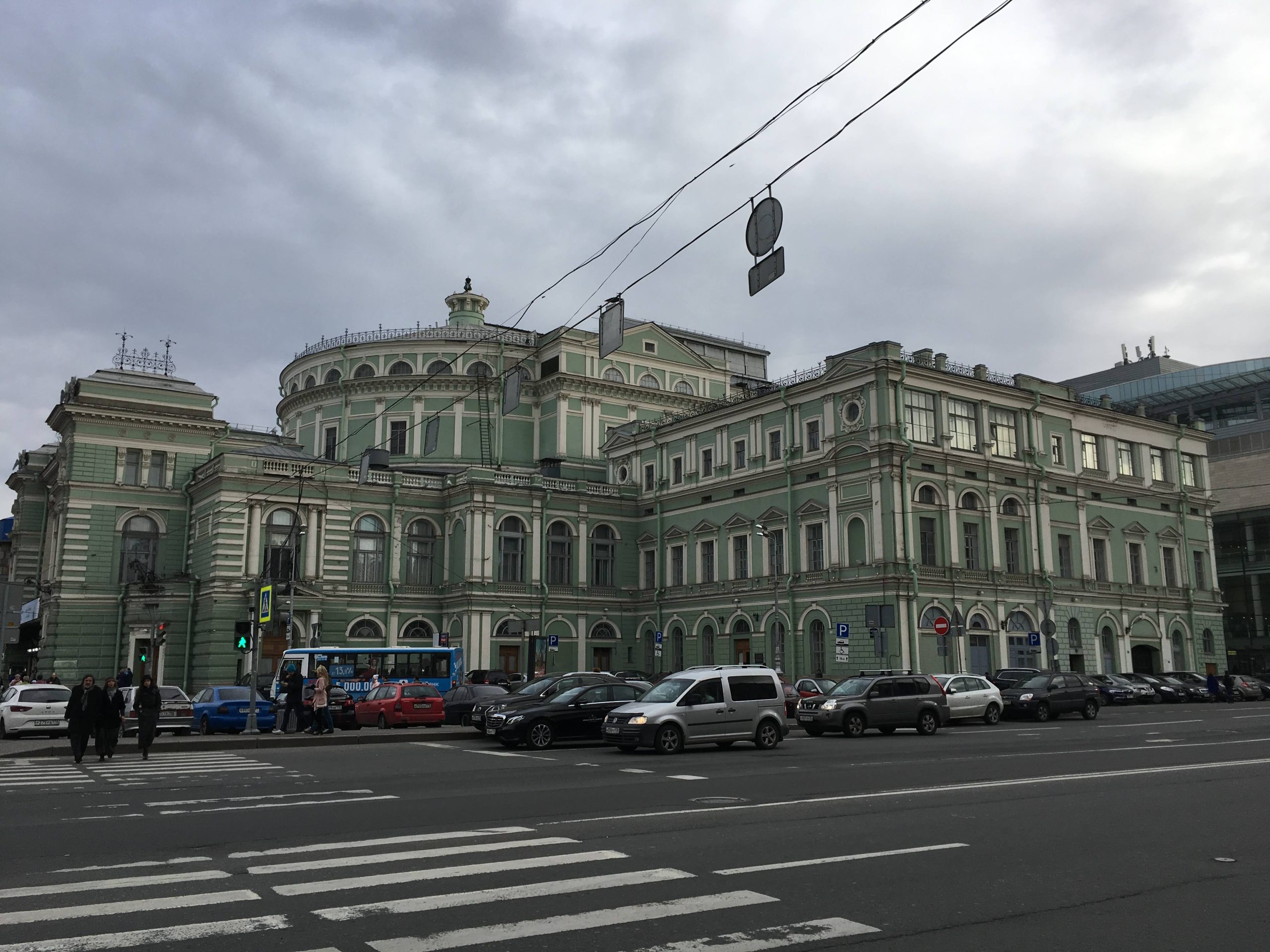 The exterior of the Mariinsky Theatre's Historic Stage in St. Petersburg, featuring a classic, understated mint-green facade under an afternoon sky.